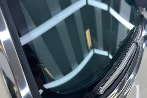 A polyurethane bonded windshield and backlite glass of a 1968 Mustang GT 2+2 Fastback